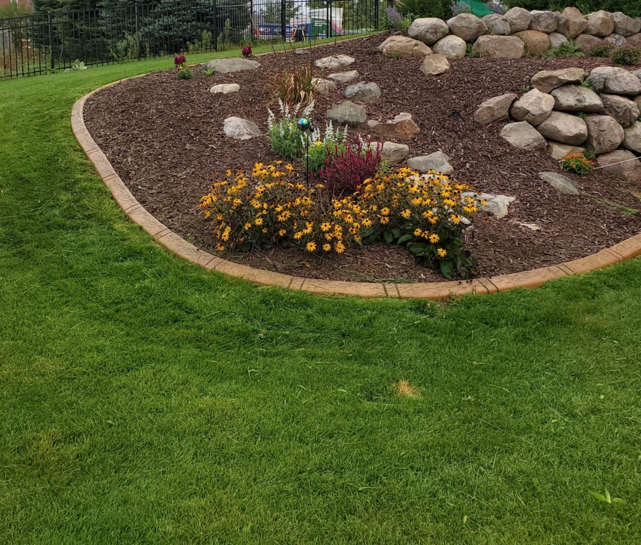 a landscaping project with flowers and stones